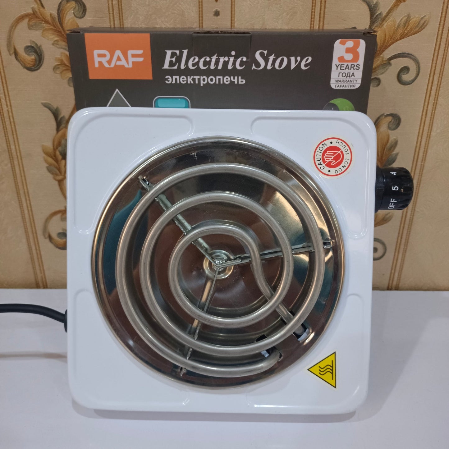 Electric stove with RAF branding on a decorative wall background