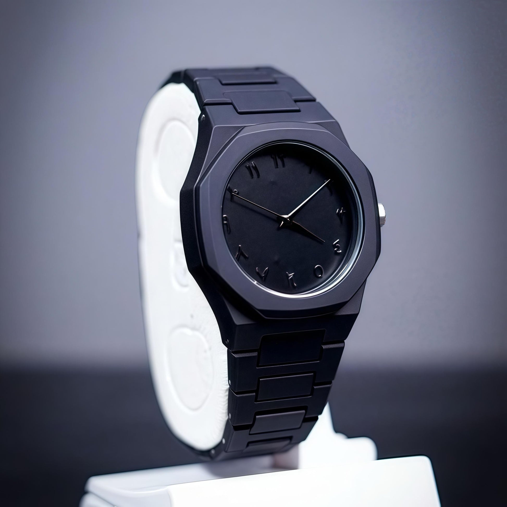 Black wristwatch on a white stand with a gray background