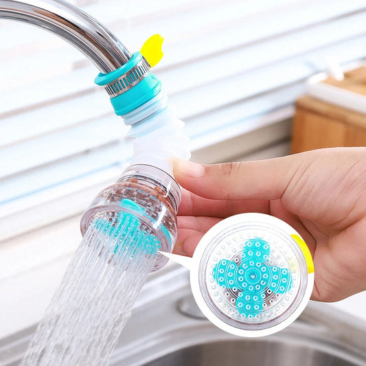 Hand holding a kitchen faucet filter with water flowing out, set against a kitchen sink background.