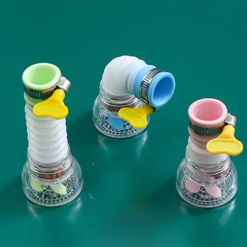 Three colorful water hose nozzles on a green background