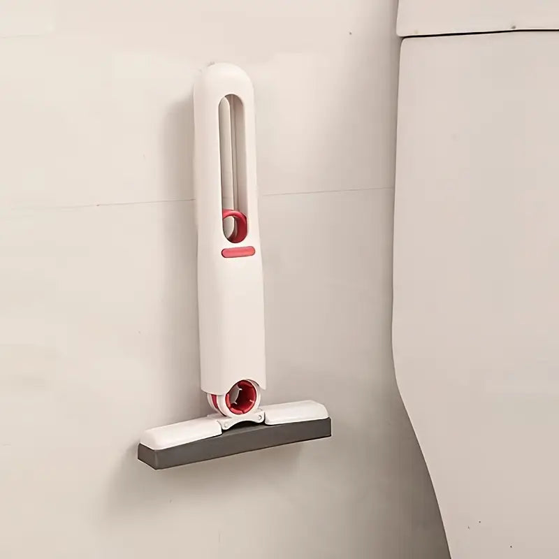 White and red cleaning tool attached to a tiled wall